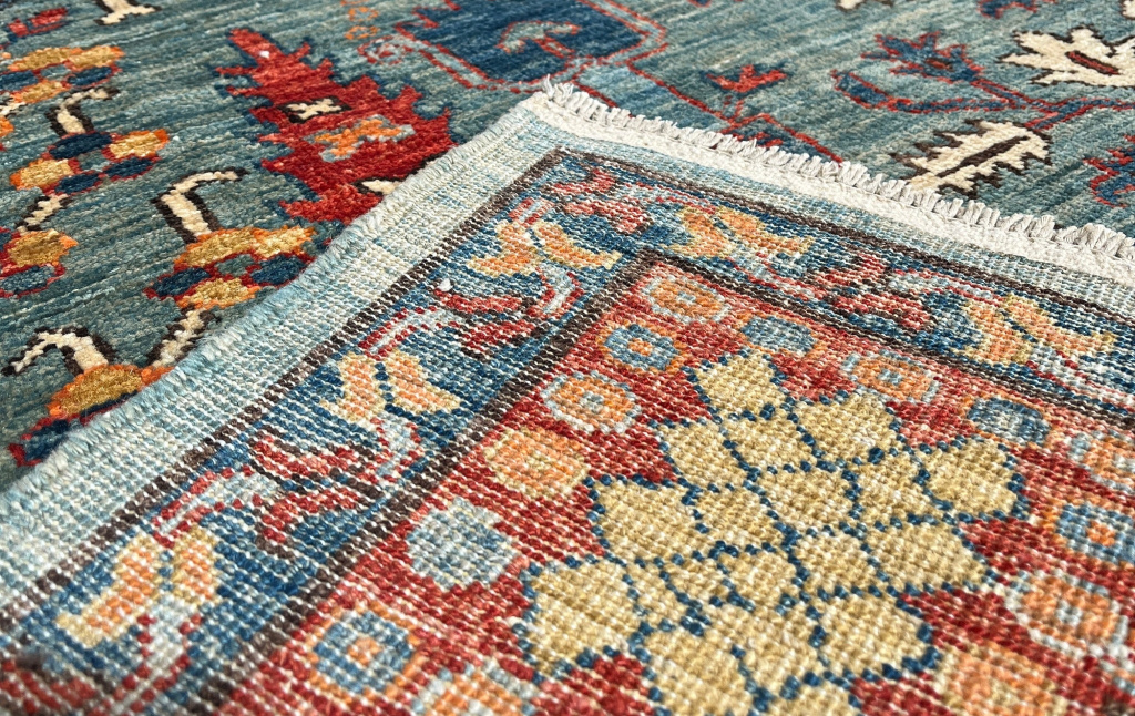 Antique rug showing hand-knotted details and patterns